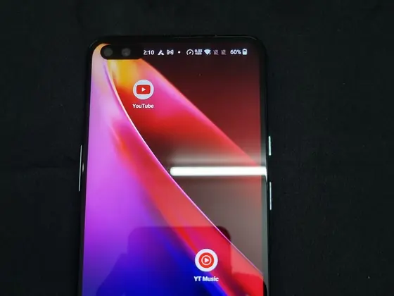 Android smartphone with a colourful home screen on a dark background