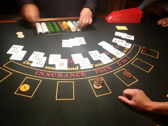 Blackjack table with cards and chips being dealt