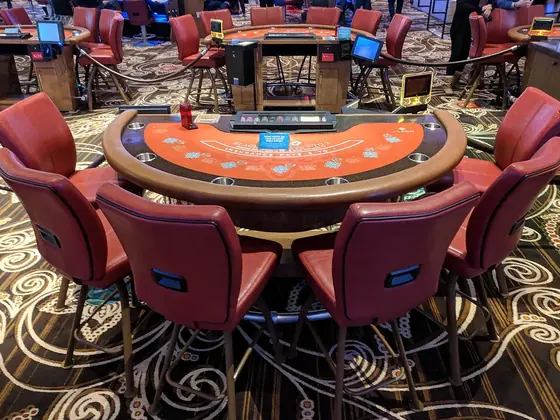 Empty table-game seats on a casino floor