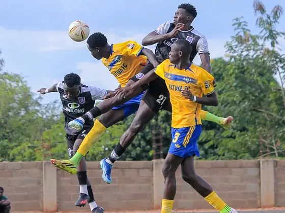 Players challenging for a header in a soccer match