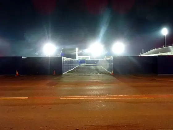 Stadium floodlights switched on at night